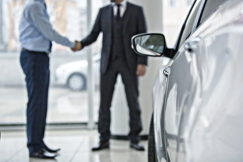Car Buyer Shaking Hands With Car Salesman Stock Photo