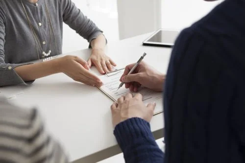 Woman Signing A Contract Or Legal Document Stock Photo