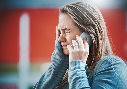 Distressed woman talking on phone