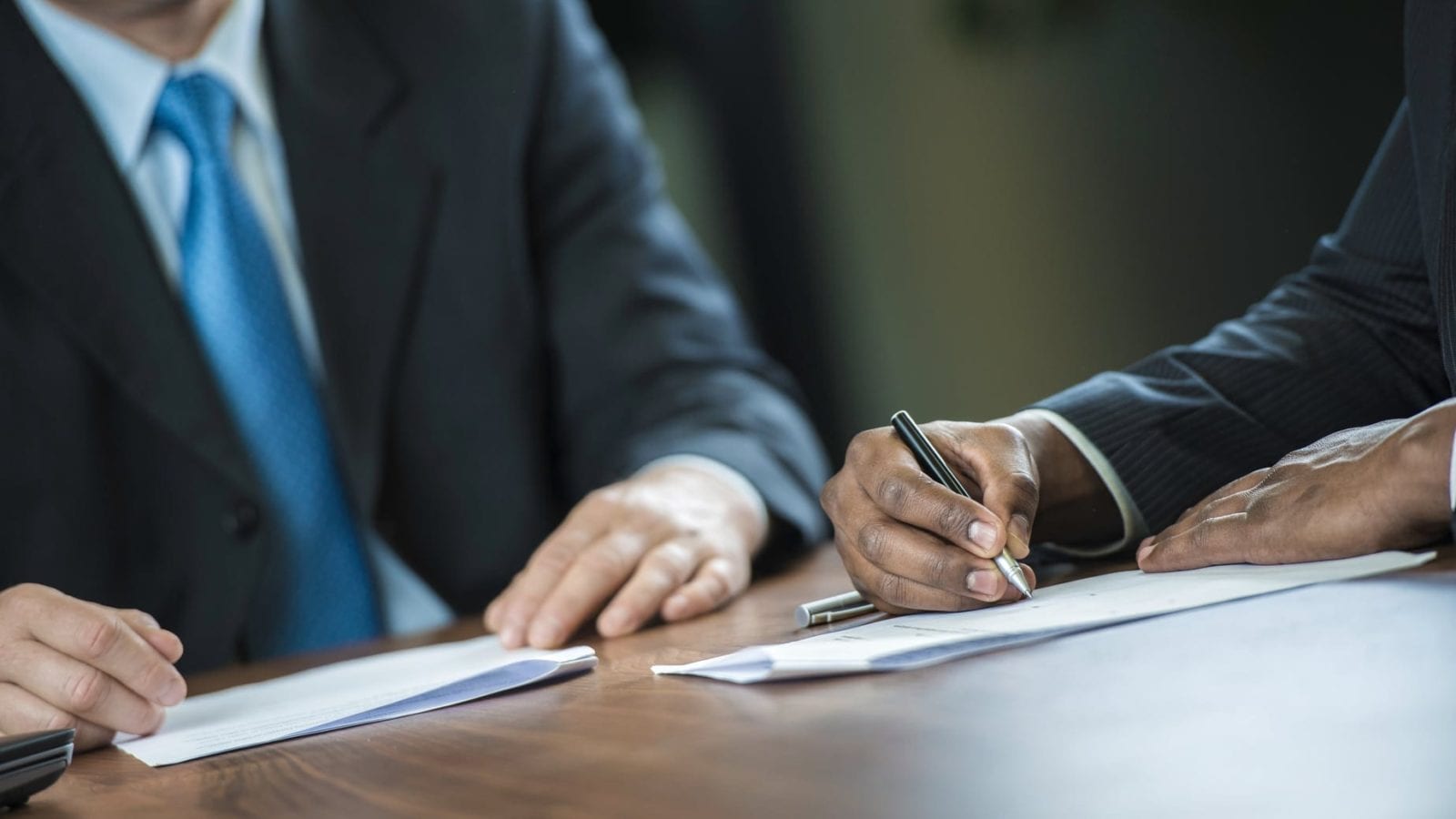 Lawyer Signing A Legal Document Stock Photo