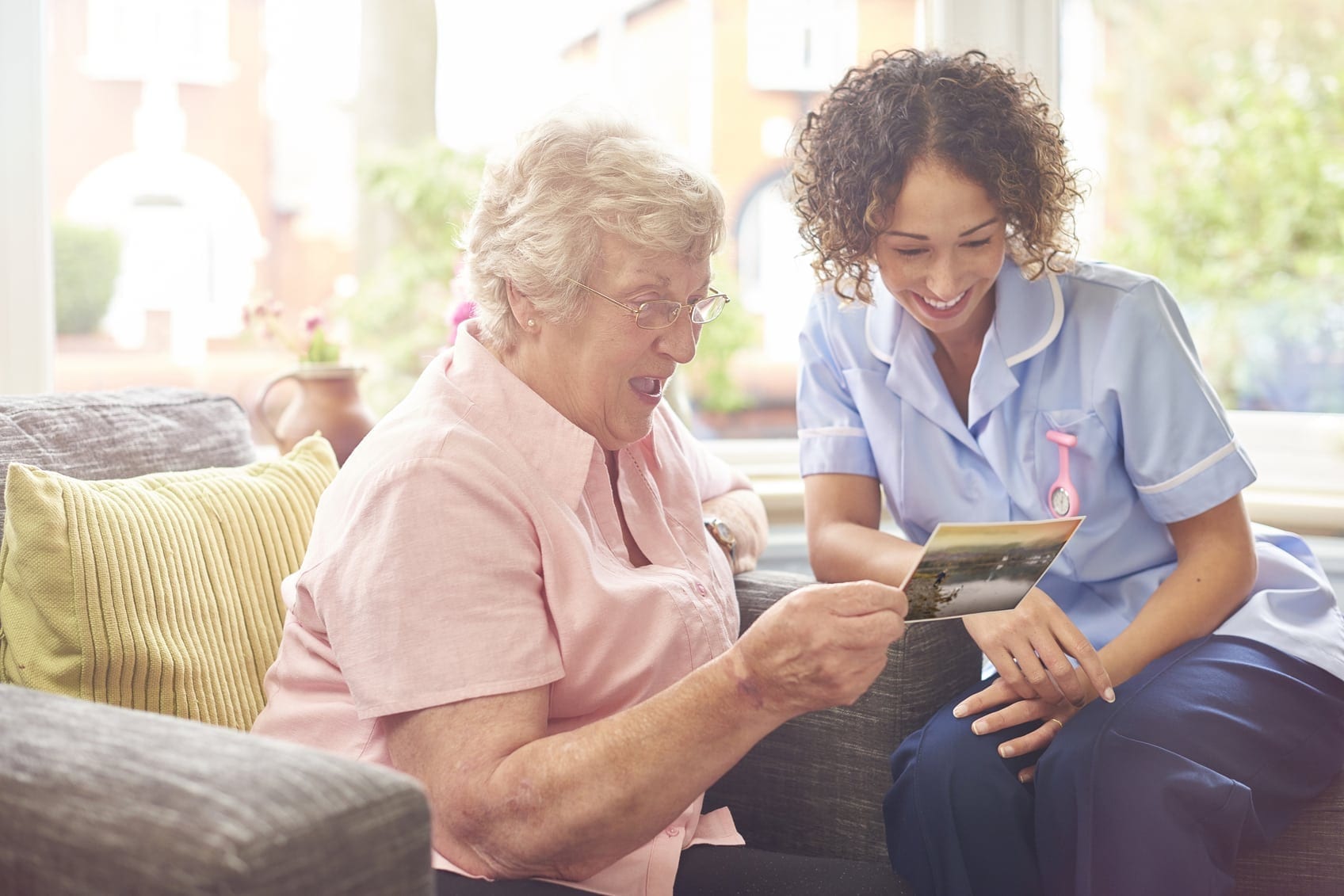 Female Nurse Spending Time With An Elderly Patient Stock Photo