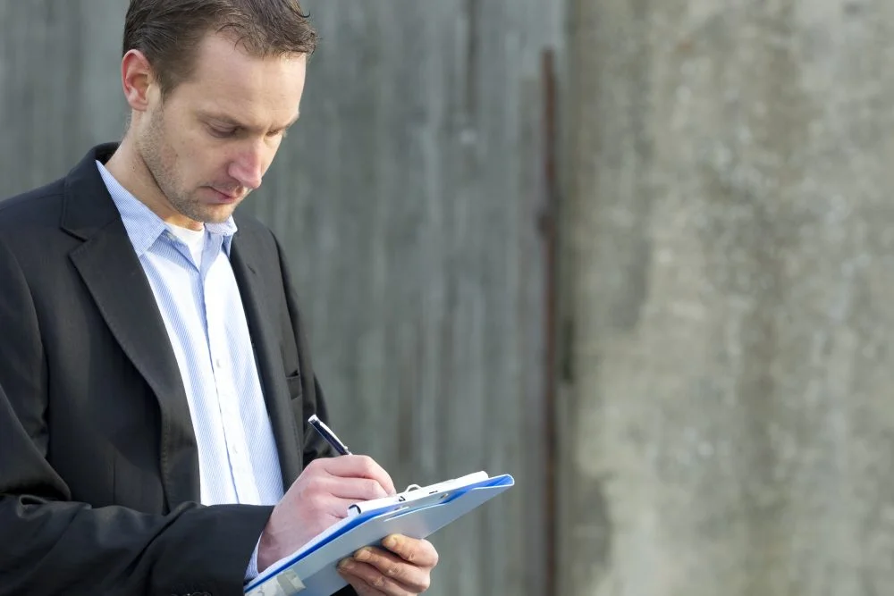 A claims adjuster from an insurance company reviews evidence from a personal injury claim.