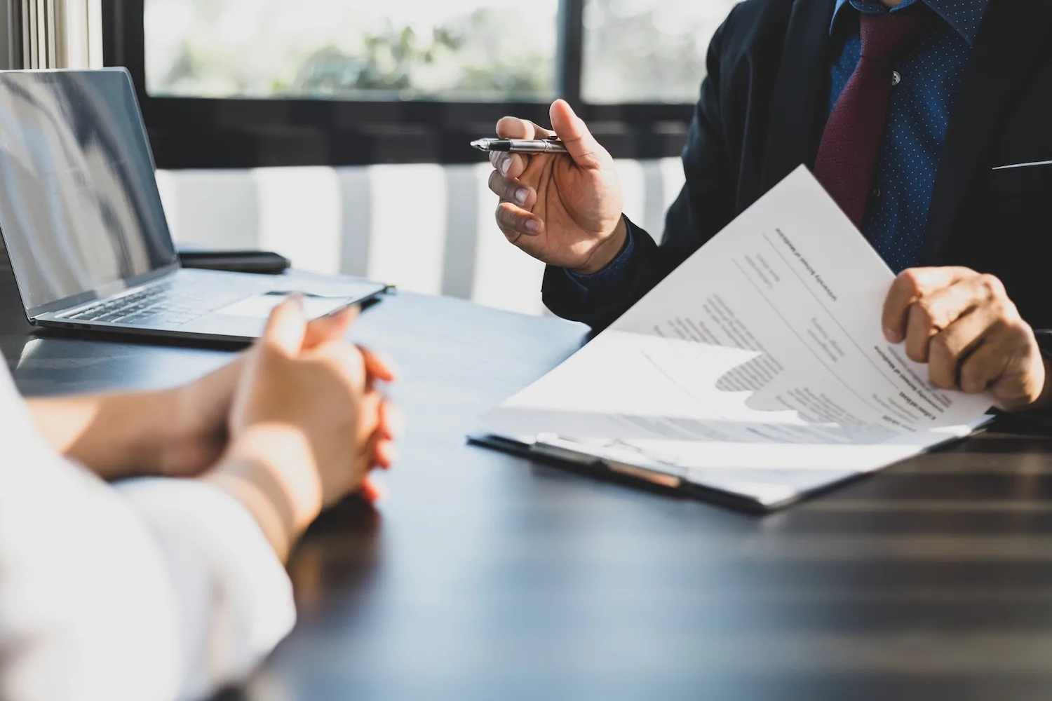 Client consulting a personal injury lawyer in their office.
