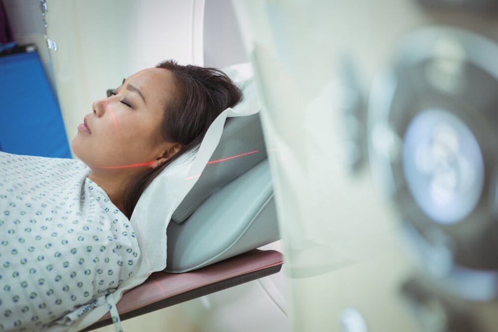 A close up of a patient going into a CT scan.