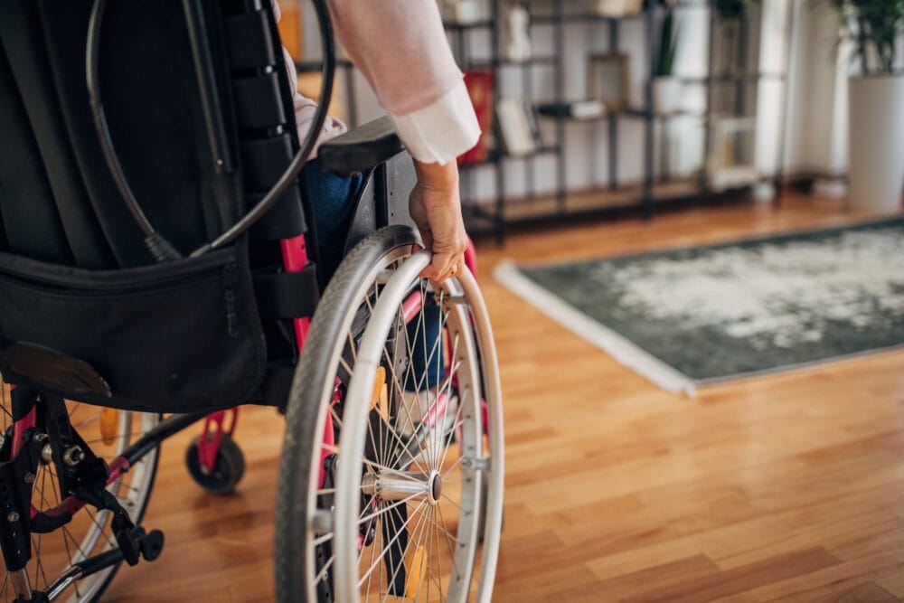 View from behind of a person in a wheelchair in their home.