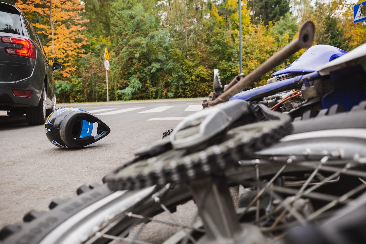 Crashed motorcycle on the side of the road.